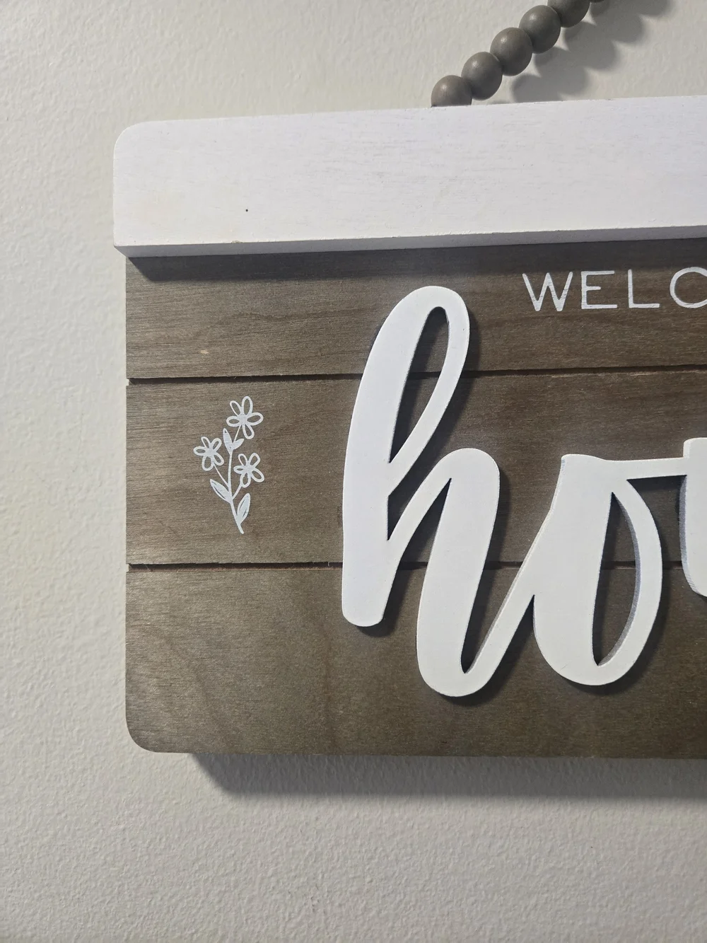Welcome to Our Home Wooden Wall Sign - White Script on Brown